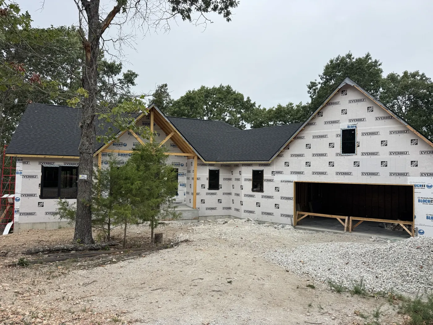 New home under construction with black-framed windows and a large garage