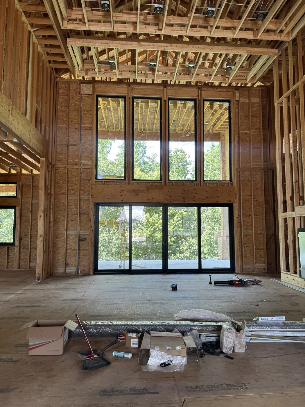 Tall window wall and a four-panel sliding door in an open great room