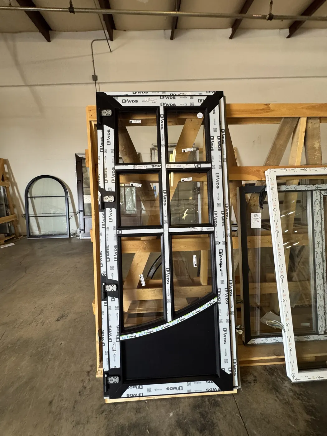 Entry door with divided panes and hinges, crated in the warehouse